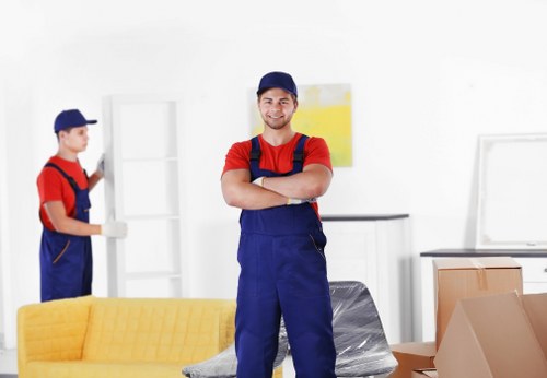 Professional movers handling furniture in a central London property
