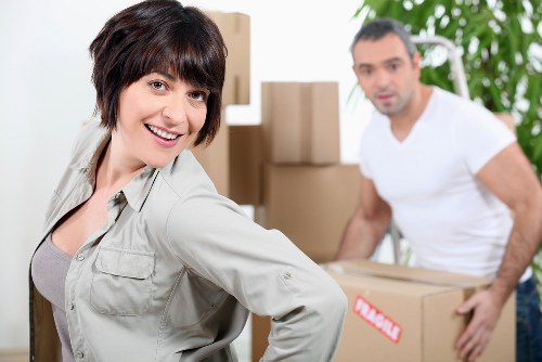 Moving crew handling furniture in a Waterloo apartment building